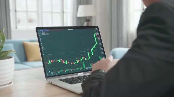 Asian Businessman Happy After Seeing Uptrend In The Trading On Computer Screen While Working At Home