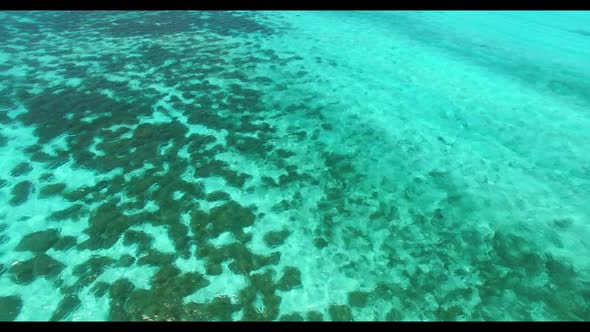 Aerial above panorama of paradise tourist beach trip by blue ocean with bright sand background of a 