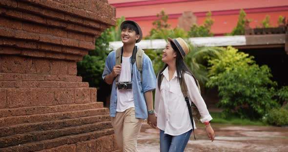 Couple hand together while visiting at ancient temple