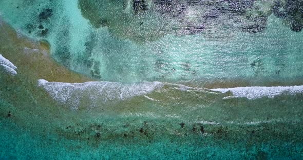 Tropical fly over travel shot of a white sand paradise beach and blue sea background in high resolut