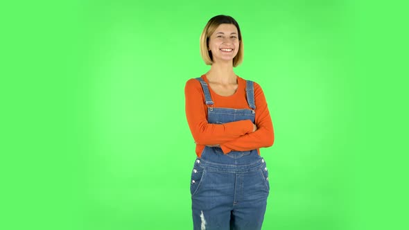 Girl Listens Carefully, Threatens with a Finger and Waves Her Head Seductively. Green Screen