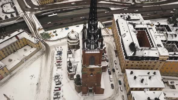 Rotating top down view over charming church with artistic steeple in the famous town of Stockholm,