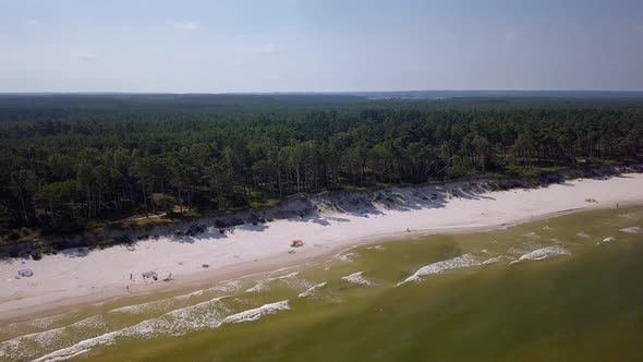 Baltic Sea beach aerial shot. Beautiful, secluded beach on Baltic Sea coast. Backwards flight and ca