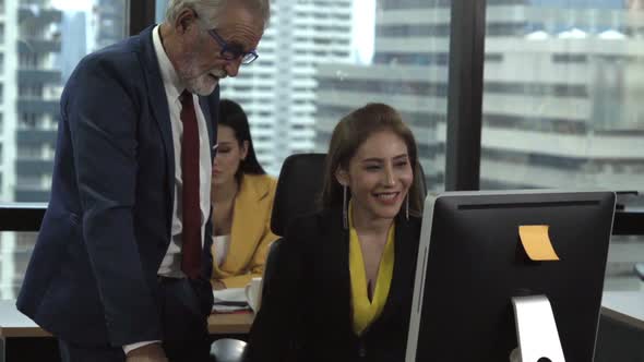 Senior Manager Gives Advice to Young Woman Worker