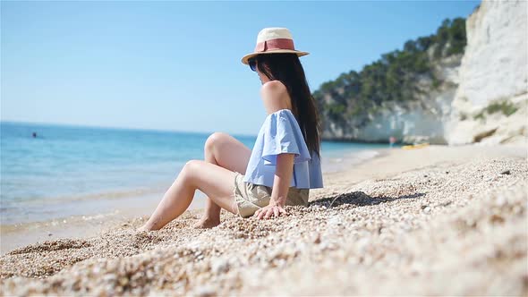 Young Beautiful Woman on White Tropical Beach