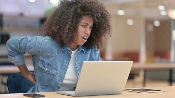 Tired African Woman Having Back Pain at Work 