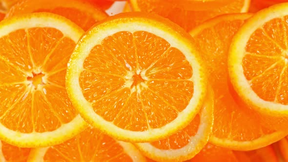 Super Slow Motion Shot of Flying Fresh Orange Slices Towards Camera at 1000 Fps alt