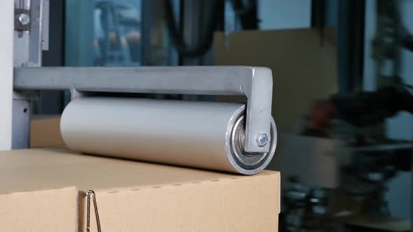 Cardboard boxes on a conveyor at distribution warehouse