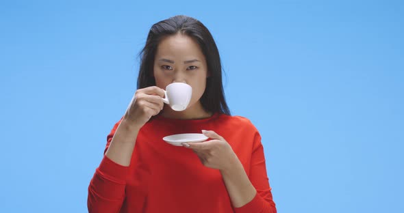 Young Woman Drinking Coffee