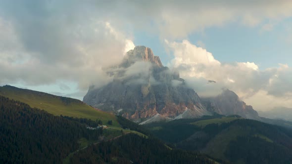 cloudy mountain top sassolungo during sunset, dolomites, south tyrol