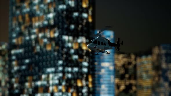 Slow Motion Helicopter Near Skyscrapers at Night