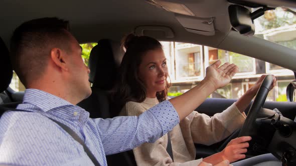 Car Driving School Instructor Teaching Woman