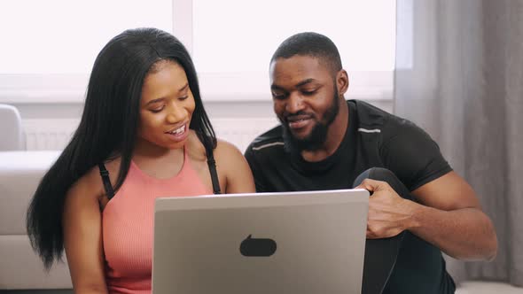 Sporty African American Couple Use Laptop Before Workout