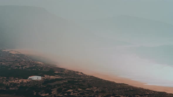 Ocean Coast and Mountains in the Thick Fog