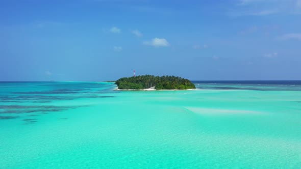 Wide overhead island view of a sunshine white sandy paradise beach and aqua turquoise water background