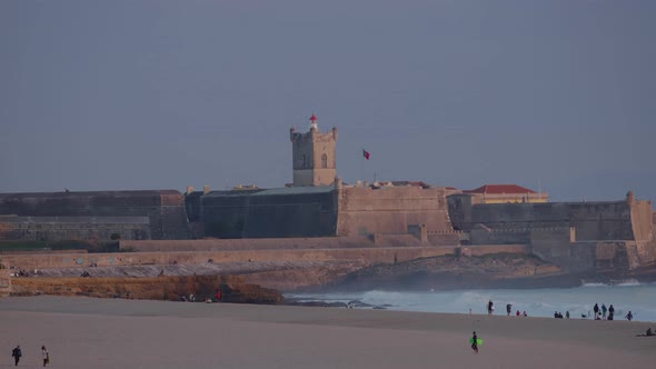 amazing view of fort saint Julian (sao juliao) in Carcavelos entering at night. Cascais in sunny day