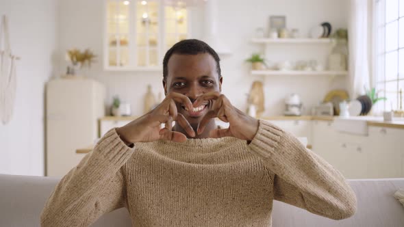 African American Man Makes Double Heart Shape with Hands