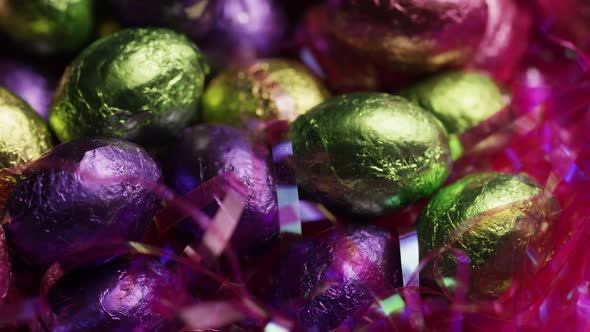 Rotating shot of colorful Easter candies on a bed of easter grass 