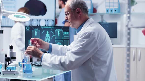 Scientist Taking Samples From Different Tubes