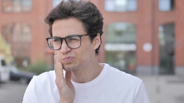 Outdoor Close Up of Young Man with Toothache