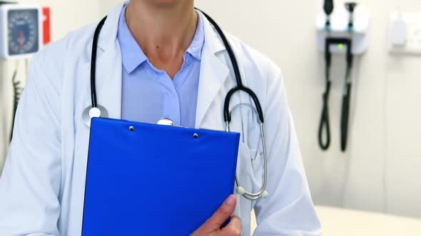 Female doctor holding clipboard