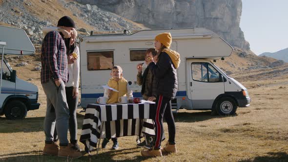 Family Eat By Table on Motorhome Road Trip