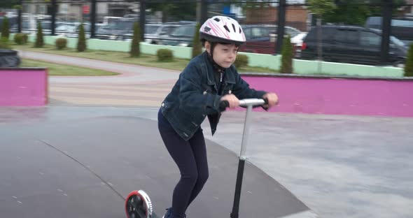 Walk with a scooter. A child on a scooter.