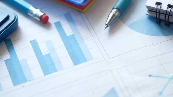 Financial Graph, Calculator and Notepad on Table 