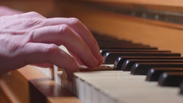 A Hand Plays One Chord On An Piano, Close Up