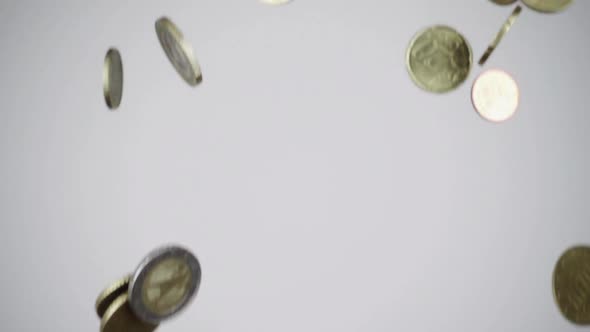 Metal coins falling on table