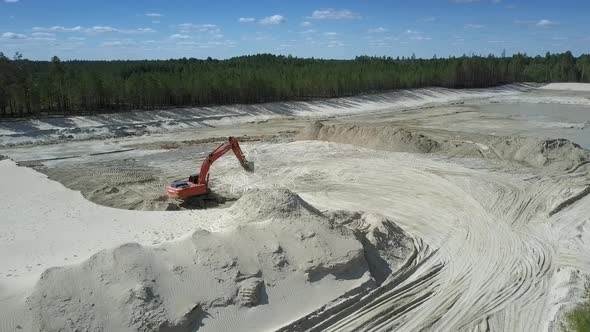 Sand Pit with High Hills and Red Digger in Summer Upper View