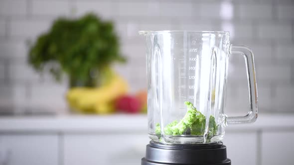 Woman Pouring Healthy Green Smoothie on Glass. Detox and Healthy Life Concept. Vegan, Vegetarian