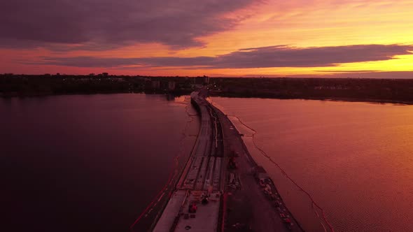 Aerial sunset over bridge under construction