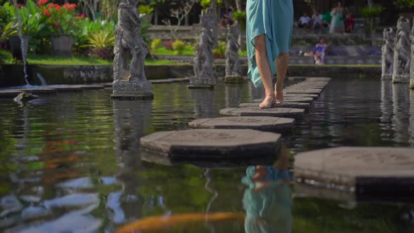 Slowmotion Shot of a Young Woman Tourist Visiting the Tirta Gangga Water Palace, Former Royal Palace