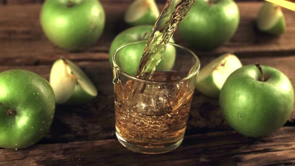 Super Slow Motion Juice From Fresh Green Apples Poured Into a Glass of Air Bubbles