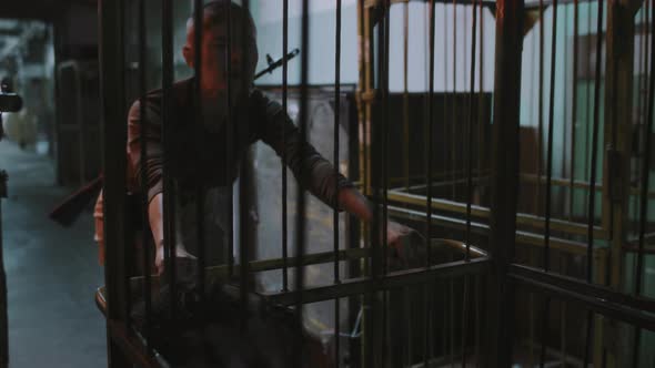 Military Woman Dragging Zombies in Cage