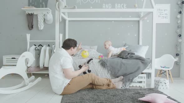 Joyful Baby Playing Toys with Beloved Dad at Home