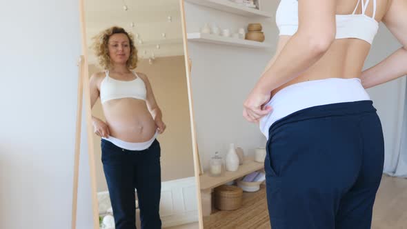 Maternity Clothes Concept. Pregnant Woman Wearing Pregnancy Trousers