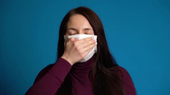 Woman Coughs Into Mask