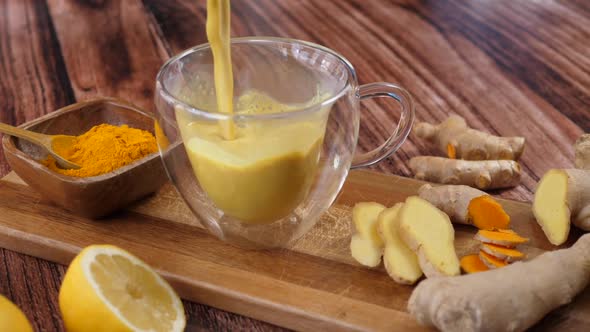 Immunity Boosting Antivirus Drink. Healthy Turmeric Latte Drink In A Glass Cup. 