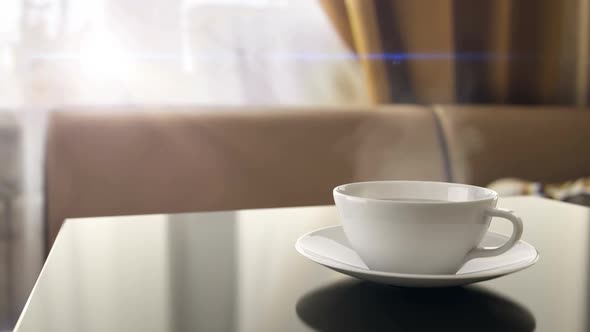 Breakfast with Cup of Hot Morning Coffee with Steam on the Kitchen Table at Home