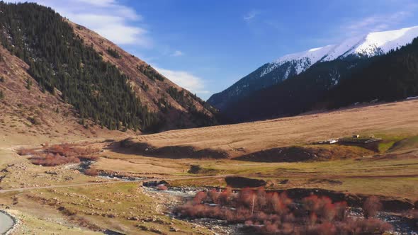 A Beautiful Spring Landscape of Valley with River and Small Farm Against Background of Large