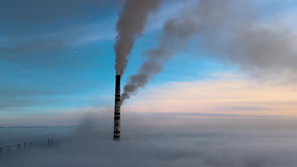 Aerial View of Coal Power Plant High Pipes with Black Smoke Moving Up Polluting Atmosphere at Sunset