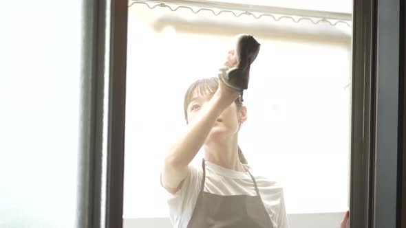 A woman cleaning the screen door