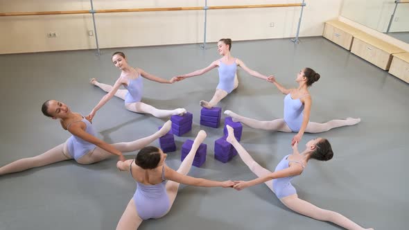 Girls in Ballet Gymnastics Class Practicing Stretching Exercise in a Group