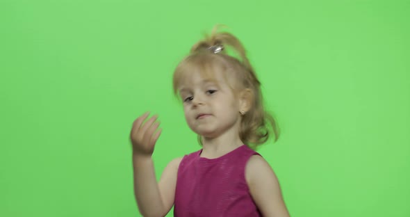 Girl in Purple Dress Dancing and Waving with Hands. Happy Child. Chroma Key
