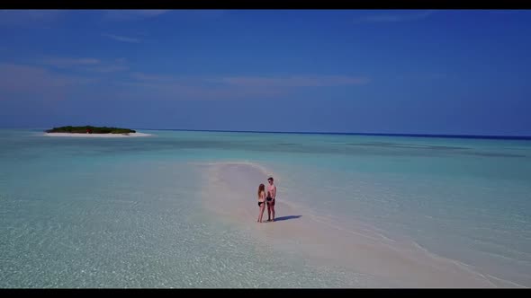 Teenage lovers tan on marine coast beach time by transparent sea and bright sandy background of the 