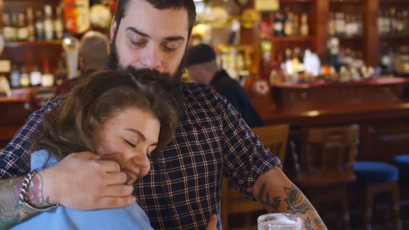 Young Couple in Love Hugging Having Drink Together at Bar