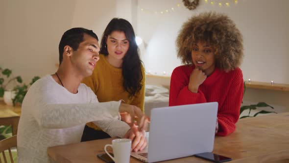 Millennial adult friends socialising together at home