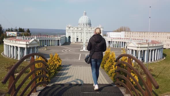 Woman Makes Photo Walking on Foot Near a Miniature Model of the Saint Peter's Basilica, Vatican